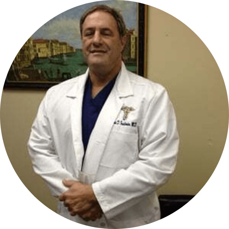 Doctor in white coat standing indoors.